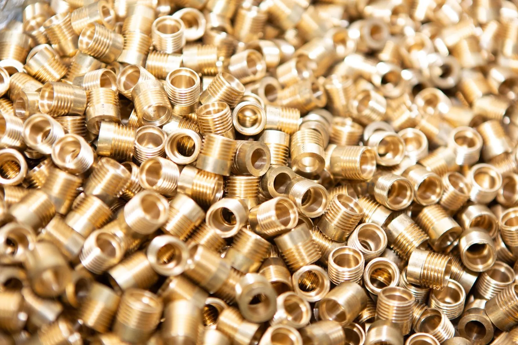 A pile of new brass pipe fittings